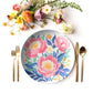 Floral peony patterned plate with cutlery and flowers on a white background
