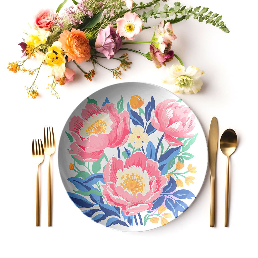 Floral peony patterned plate with cutlery and flowers on a white background