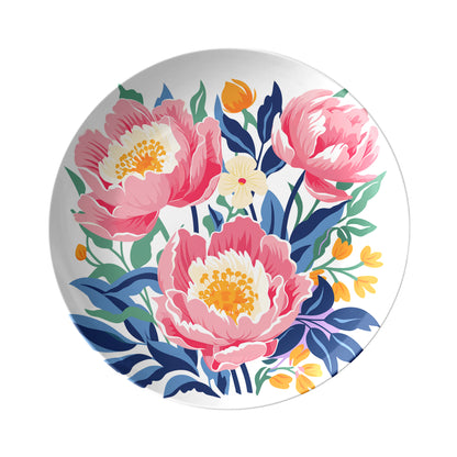 Decorative plate with pink peony floral design on a white background