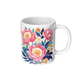 White ceramic mug with peony floral design on a white background