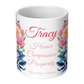 White mug with floral designs and text on a white background