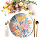 Floral-patterned marigold flower plate with gold cutlery and flowers on a white background