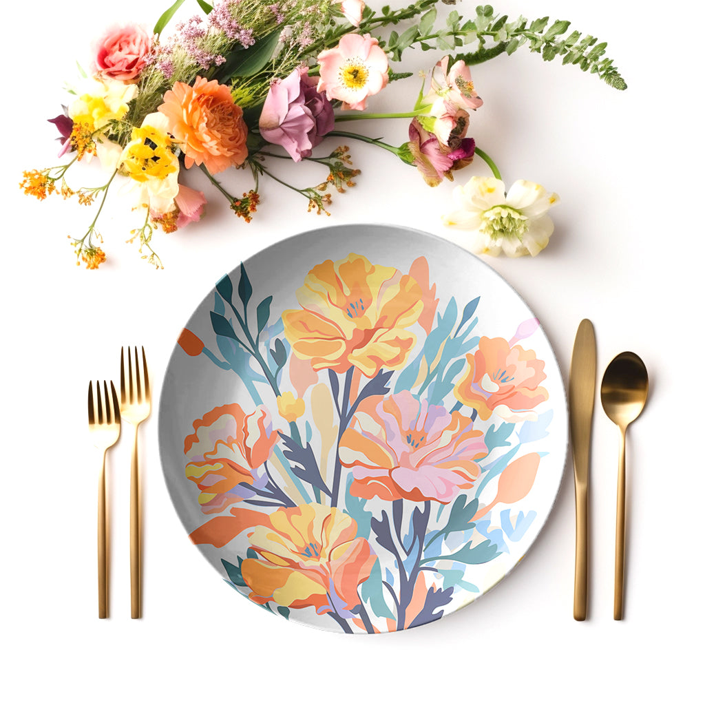 Floral-patterned marigold flower plate with gold cutlery and flowers on a white background