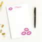 Personalized Notepad with hot pink lip prints and custom text, surrounded by gold clips and a pen on a white background.