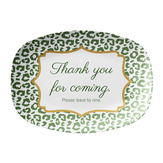 Oval serving platter has a green leopard print pattern and a funny saying that says "thank you for coming, please leave by nine". 