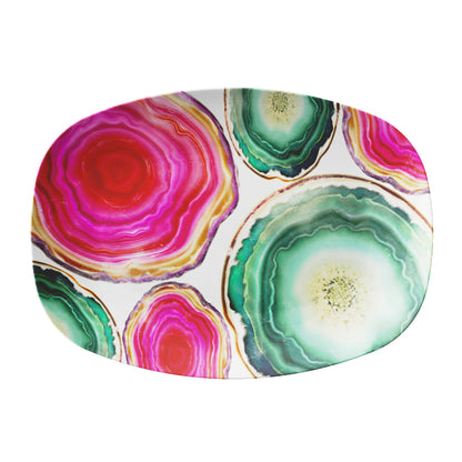 Colorful pink and green agate patterned serving platter on a white background