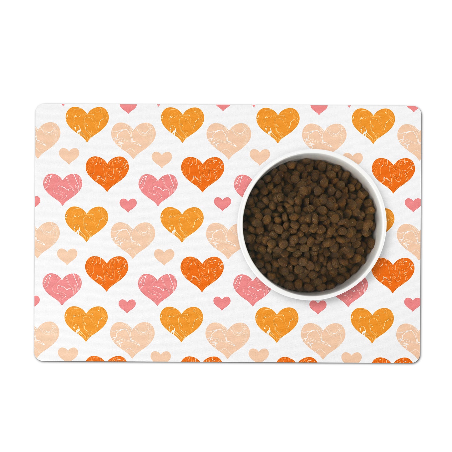Orange and pink hearts are printed all over a white pet placemat.