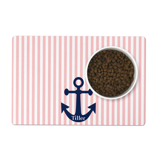 Pink and white striped nautical pet placemat with a blue anchor and custom pet name featuring a bowl of pet food.