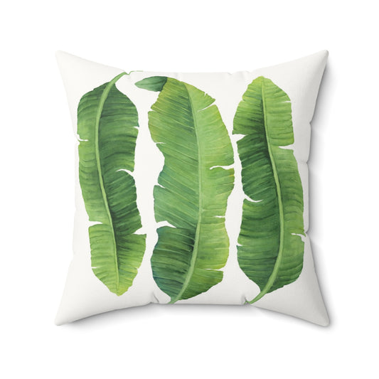 Pillow with green banana leaf pattern on a white background