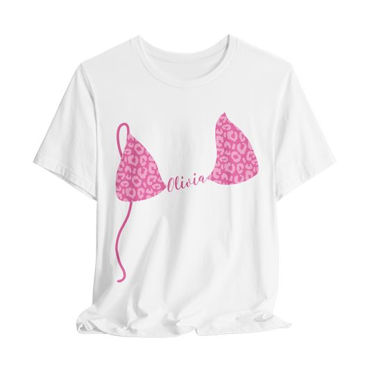 White graphic t-shirt with pink leopard print bikini top and custom text on a white background