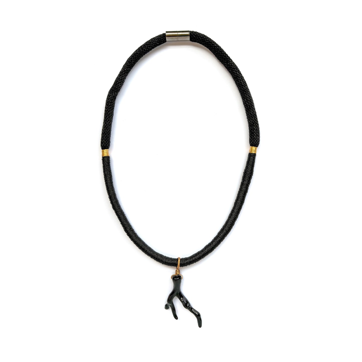 Black braided rope necklace with black sea coral branch pendant, gold accents on a white background