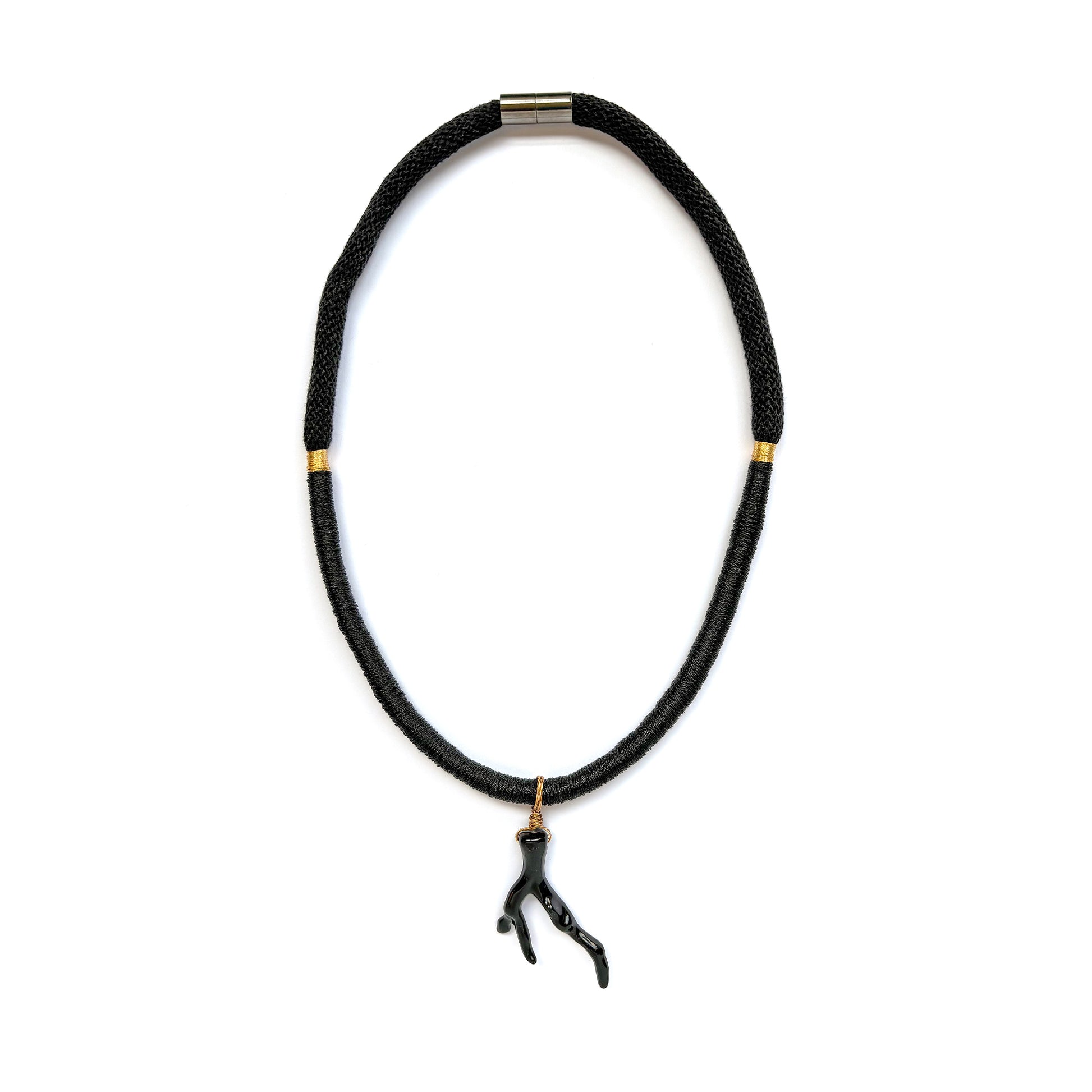 Black braided rope necklace with black sea coral branch pendant, gold accents on a white background