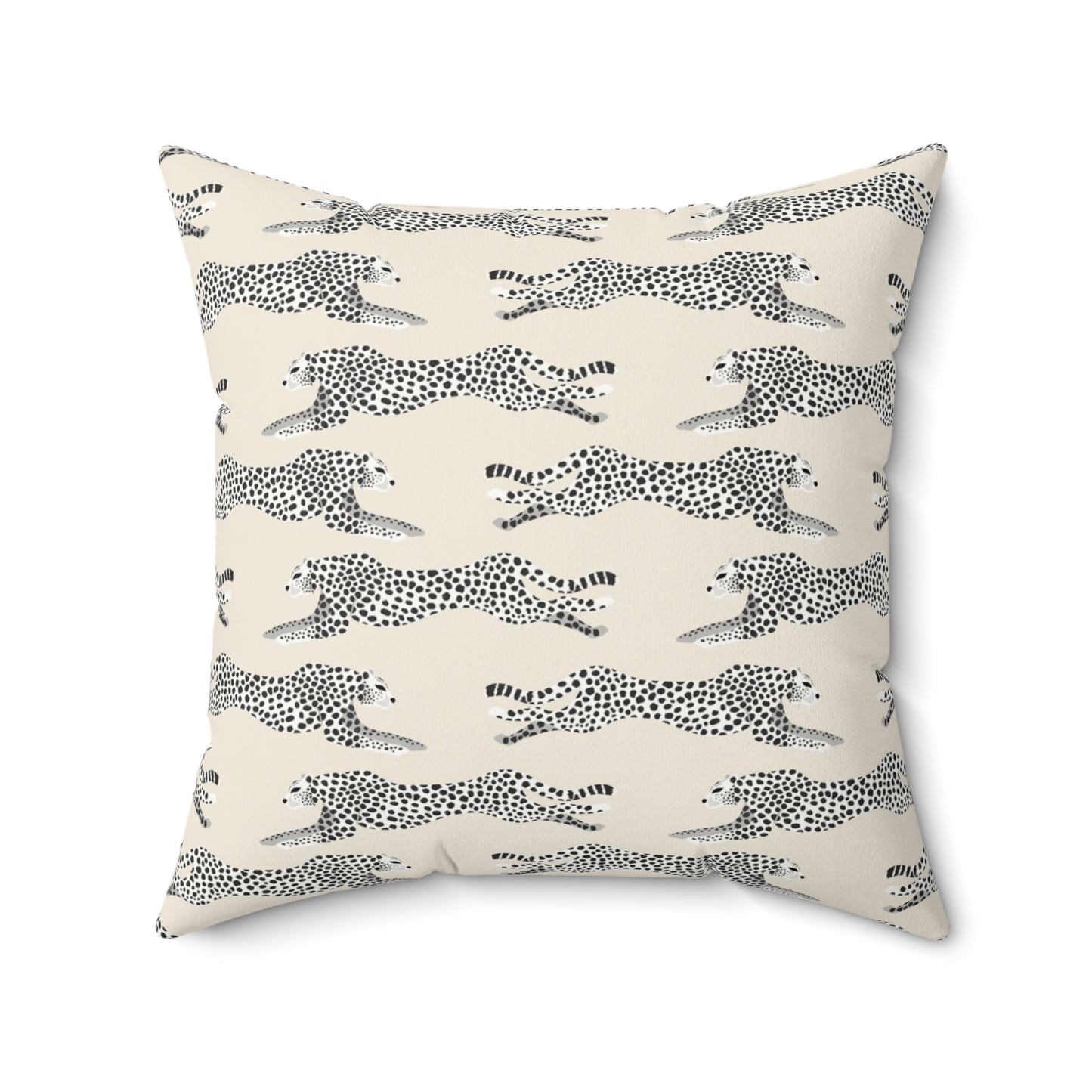 Decorative pillow with black and white cheetah pattern on a cream background