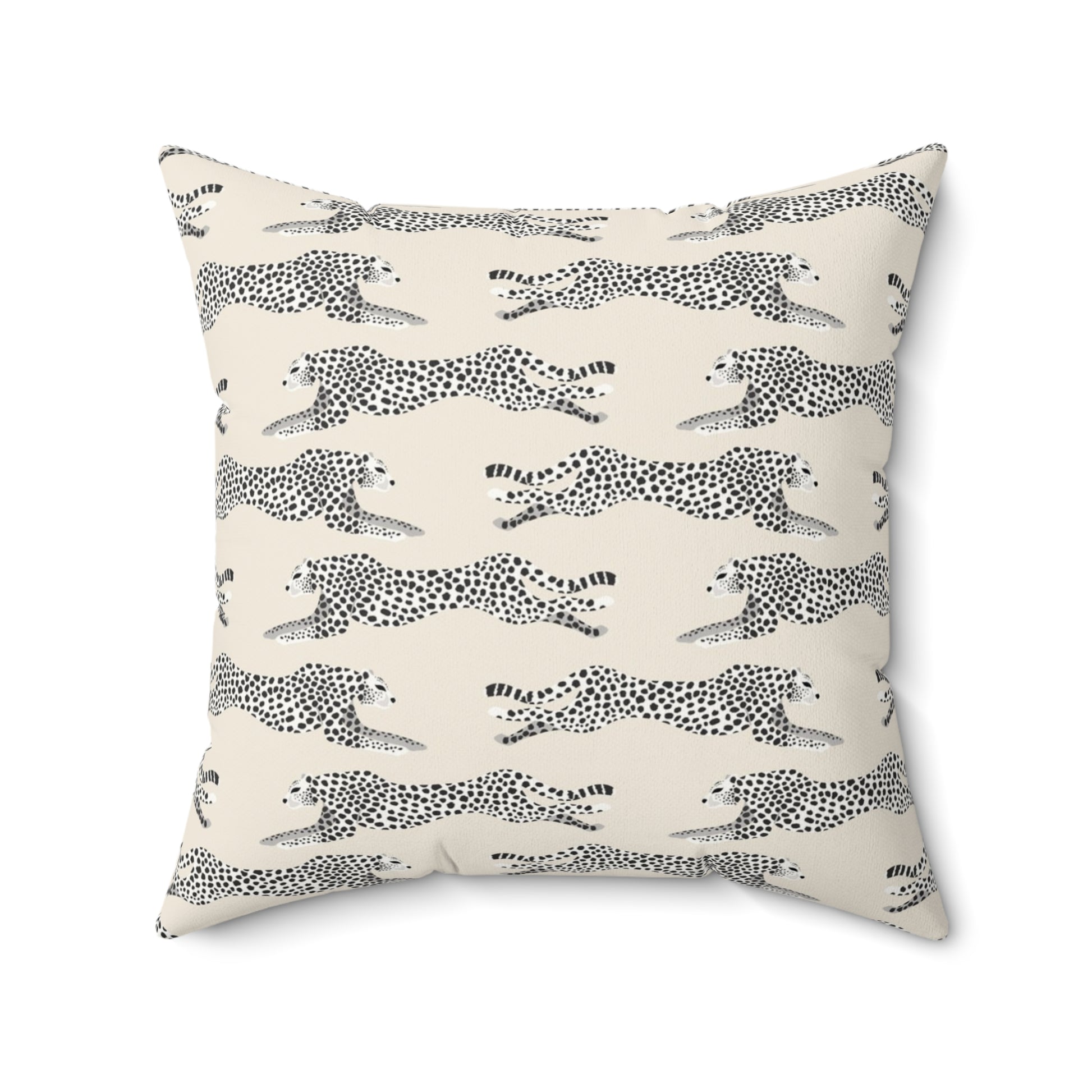 Decorative pillow with black and white cheetah pattern on a cream background