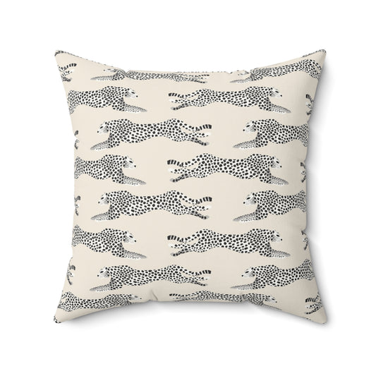 Decorative pillow with black and white cheetah pattern on a cream background