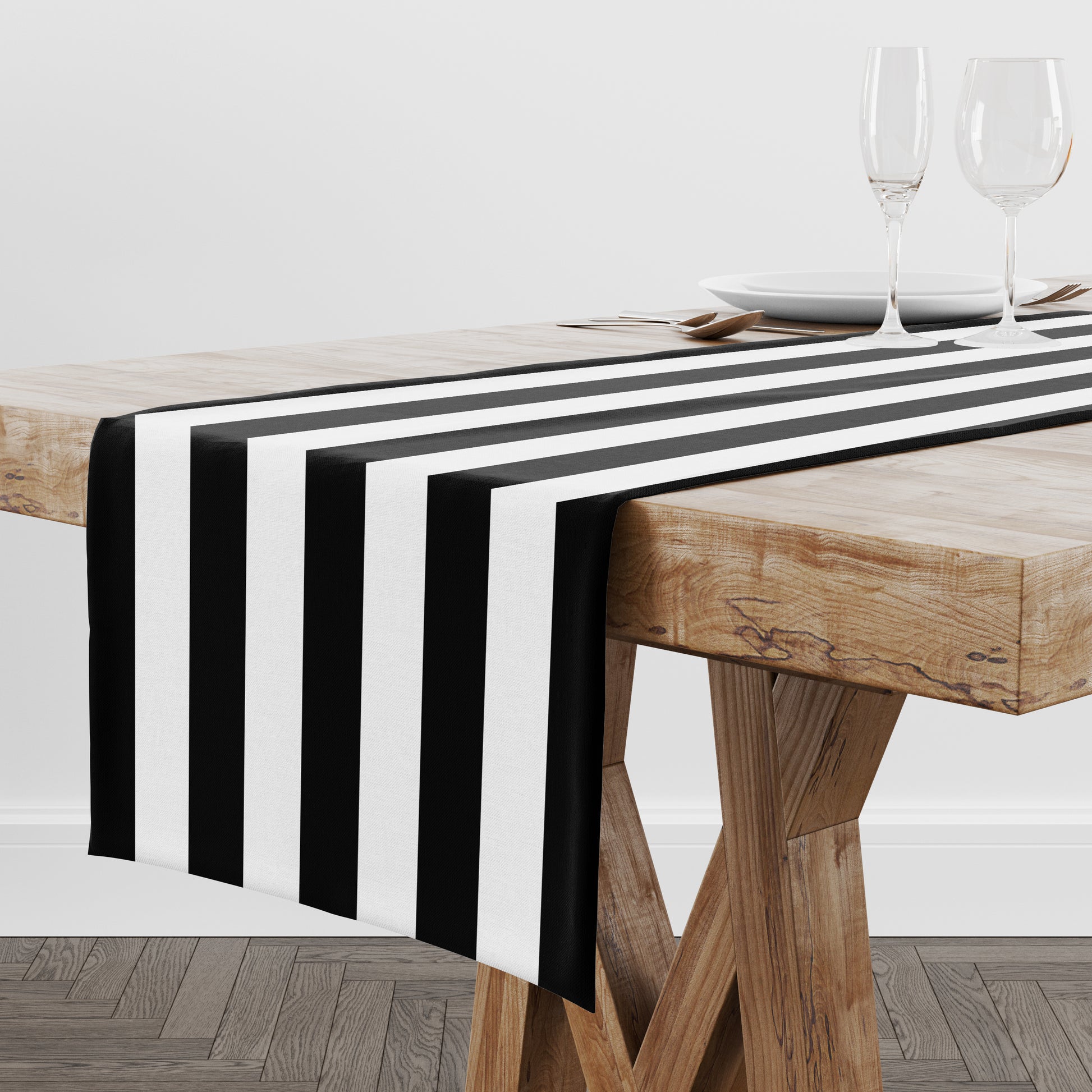 Black and white stripe table runner shown on a wood table.