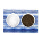 Two bowls on a blue and white striped placemat with one bowl containing cat food.