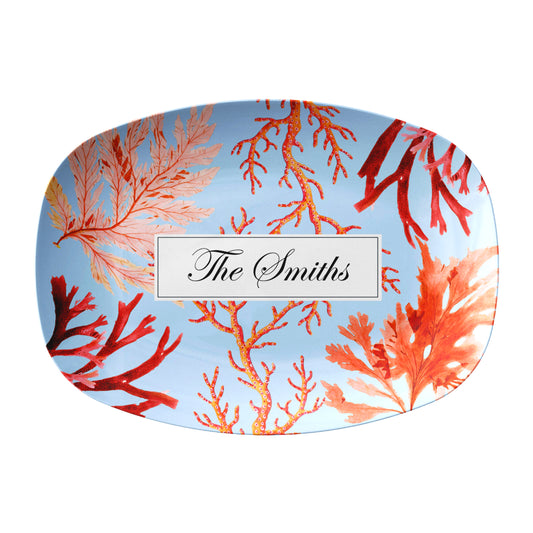 Custom serving platter with pink and red sea coral print on blue with personalized name at center