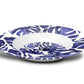 Wide rimmed plastic soup plate bowl with tropical leaf print in blue and white.