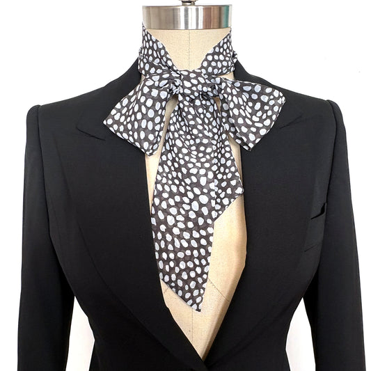 Brown & White animal spots print blousy bow scarf on mannequin with black jacket