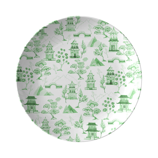Green pagodas, trees, mountains and bridges are printed on this chinoiserie toile inspired white dinner plate.