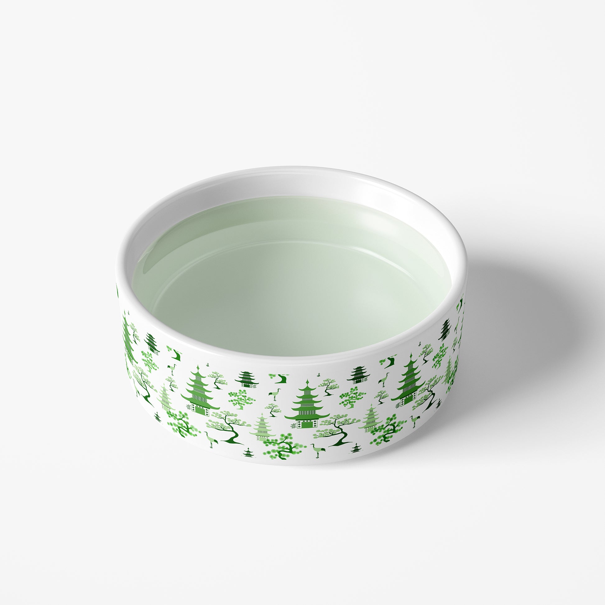 Heavy ceramic dog bowl is spill proof and features a pretty green and white chinoiserie print
