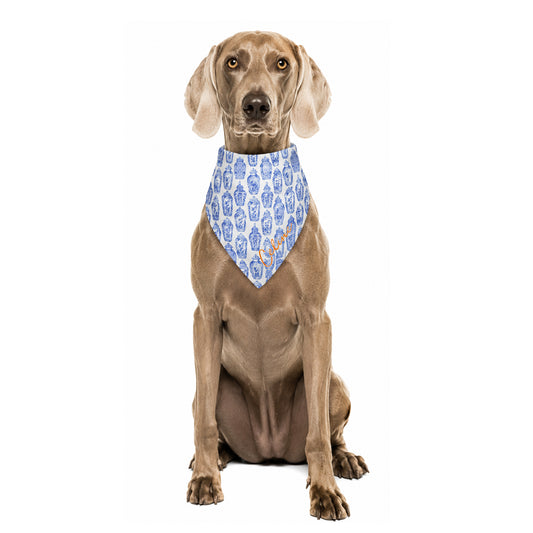 Dog wearing a custom blue and white ginger jars print bandana with personalized name on a white background