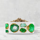 White ceramic pet bowl with emerald green and gold jeweled print. 