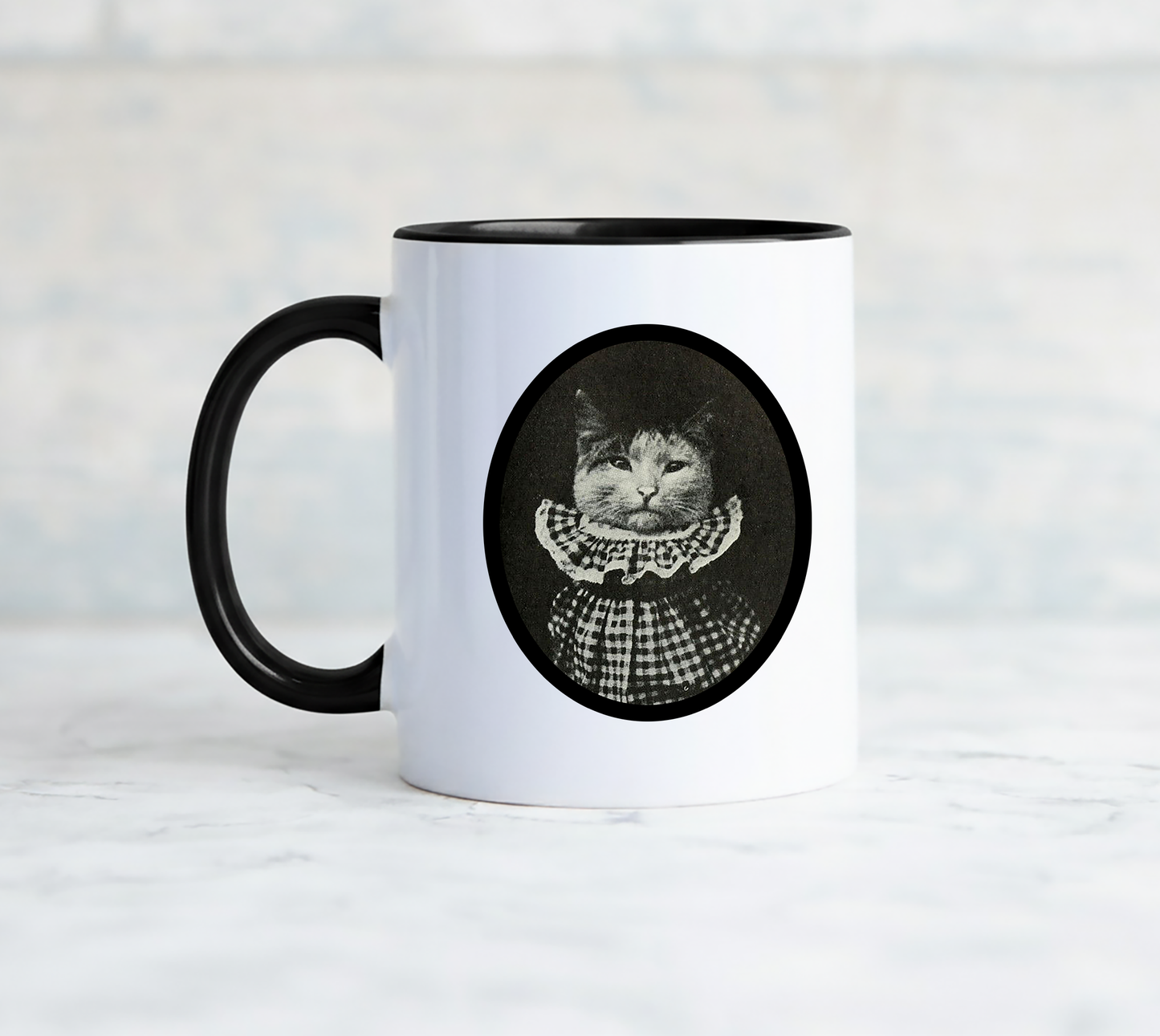 White mug with a black handle features a vintage cat in a gingham ruffled collar and says i am pretending to tolerate you.