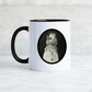 White mug with black handle has a grainy vintage cat portrait printed on one side while the funny phrase You may exist but I notice nothing is printed on the other side.
