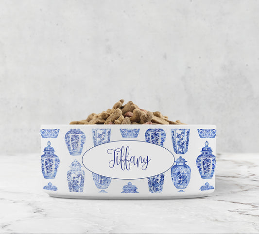 Blue and white chinoiserie ginger jars are printed on a glossy white pet bowl that is personalized with any name or word for your dog or cat.