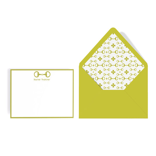 Note card with chartreuse green border and horsebit design, matching envelope with patterned interior on a white background