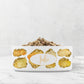 Personalized ceramic dog bowl has yellow citrine and gold jewel gems printed on white glossy bowl, customized with any name or word.