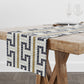 Bistro tile fretwork pattern table runner on wood dining table