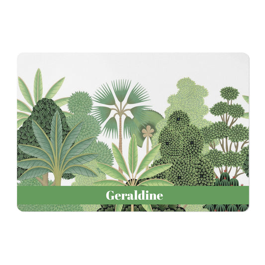 Personalized pet mat with tropical trees print in green and white for pet food bowls.
