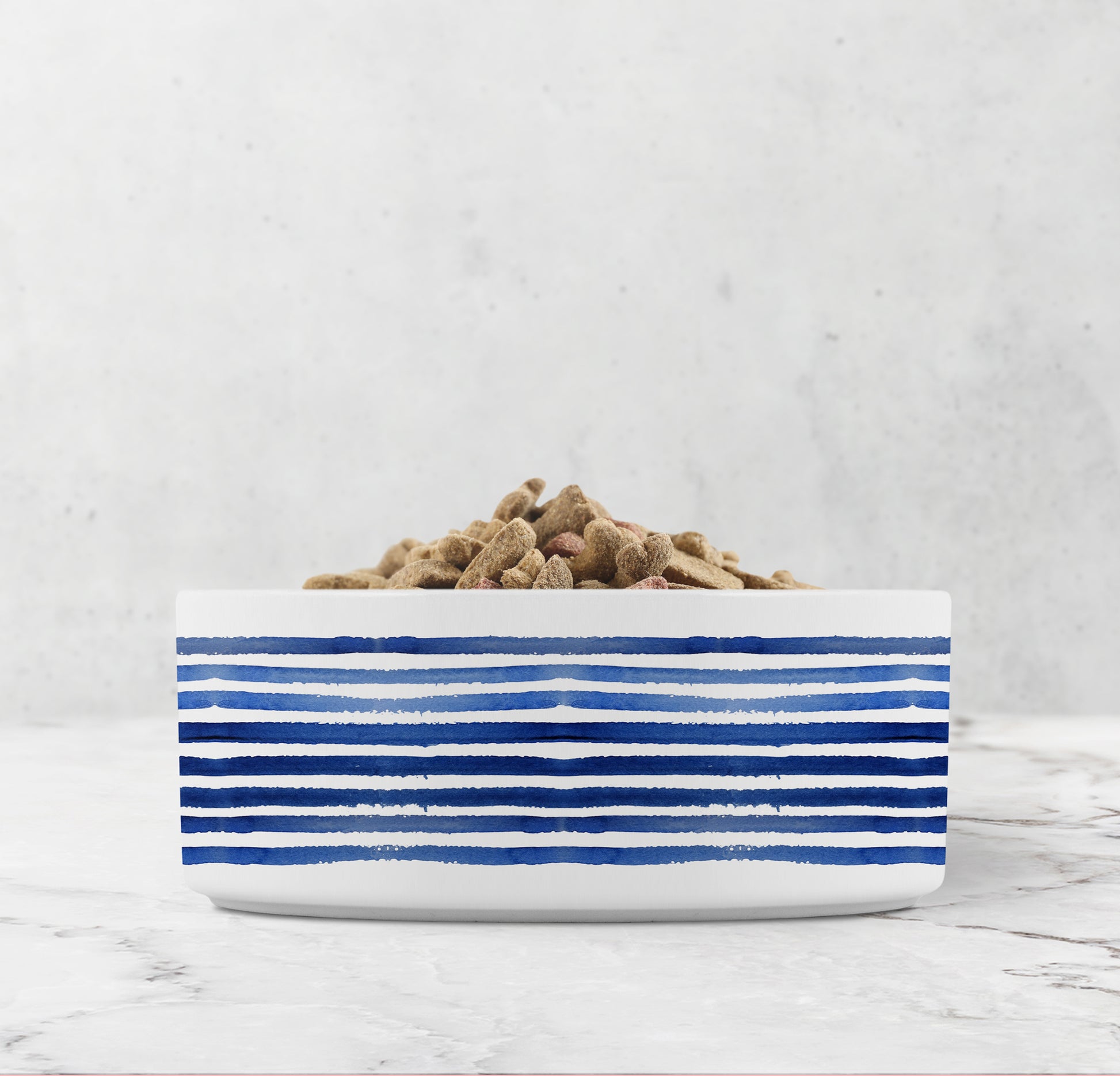 White bowl with blue stripes filled with pet food on a light gray background