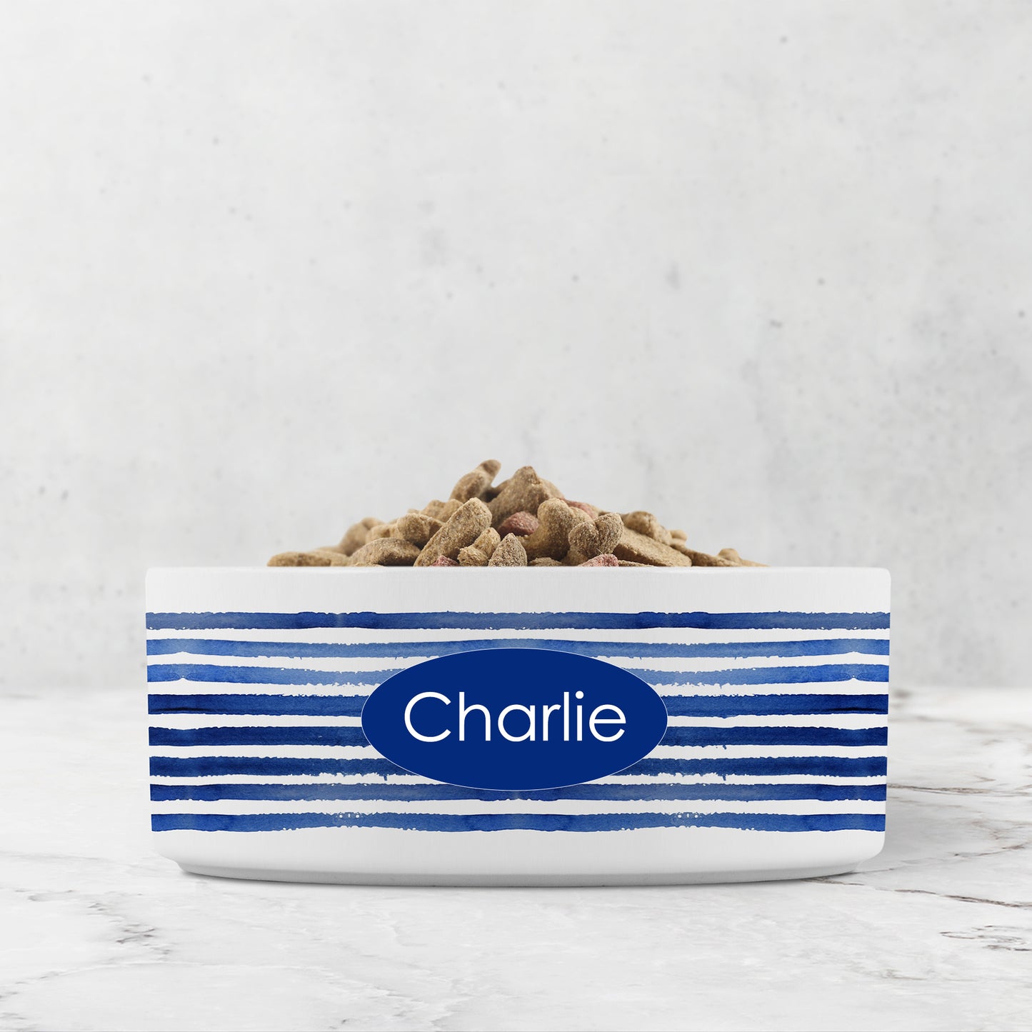 White pet bowl with blue stripes personalized with a custom name or word.