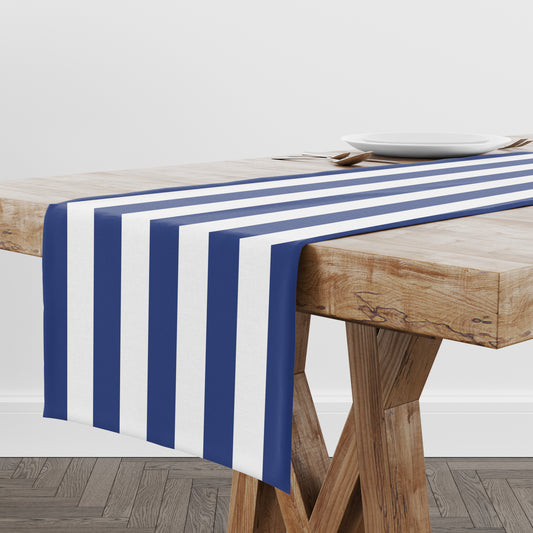 Nautical-themed blue and white striped table runner on a wooden table.