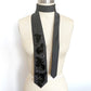 Black embellished necktie scarf with floral beaded sequin appliques draped on a mannequin