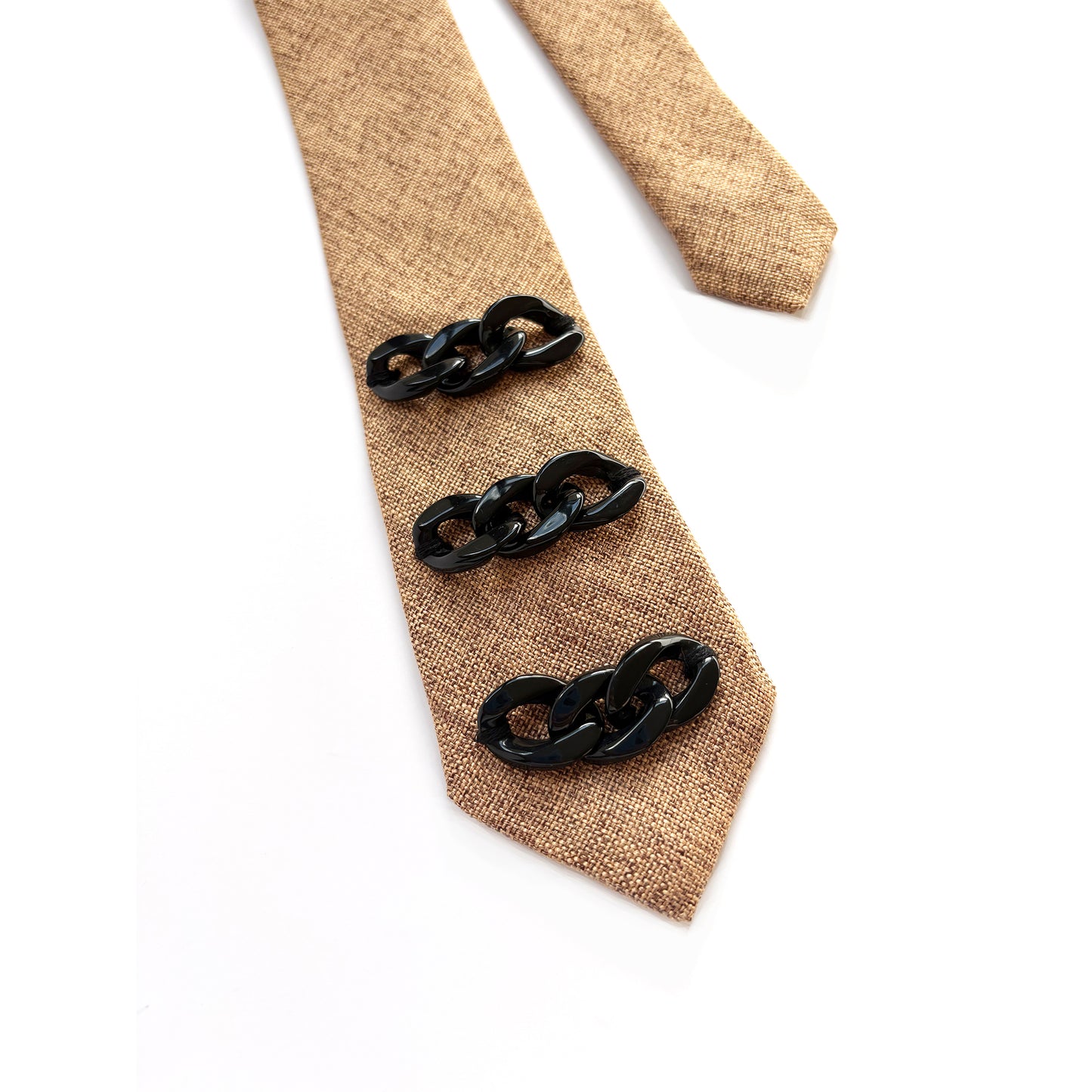Beige tie with black chain links on a white background