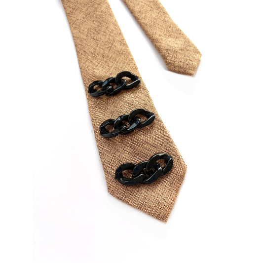 Beige tie with black chain links on a white background