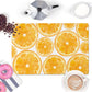 Colorful kitchen counter mat has sliced oranges pattern on one side and nonskid rubber back.