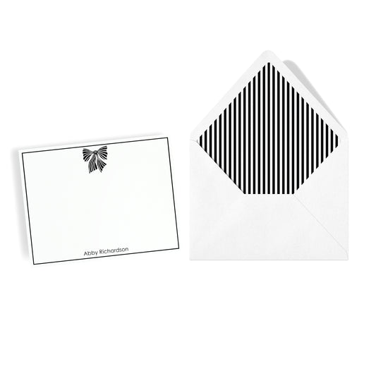 Fashion black and white bow motif notecard set with border and custom name and coordinating stripe lined envelope