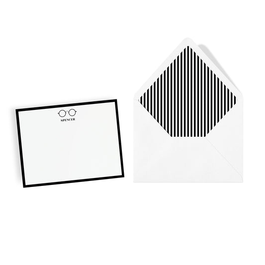 Custom monogram stationery with wire eyeglasses motif and and striped envelope on a white background
