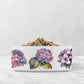 White pet bowl with floral design on a marble surface