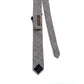 Black and white houndstooth plaid skinny necktie backside with brand label REUVEN