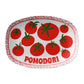 Decorative serving platter with red tomatoes and 'Pomodori' text on a white background