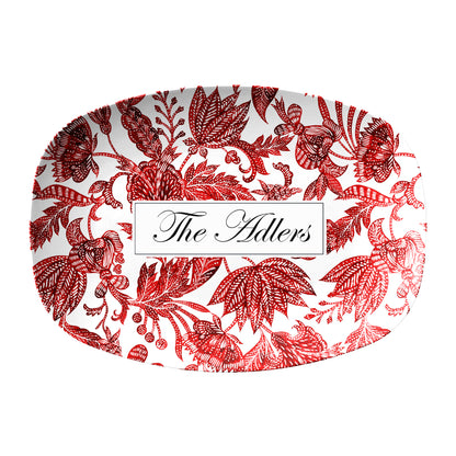 Red floral batik pattern is printed on an oval white serving platter, personalized with any name or text.