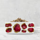 White ceramic pet food bowl with ruby red and gold jewel print