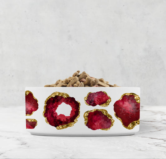 Luxury dog bowl made from ceramic has gorgeous ruby red and gold jewels printed on it.